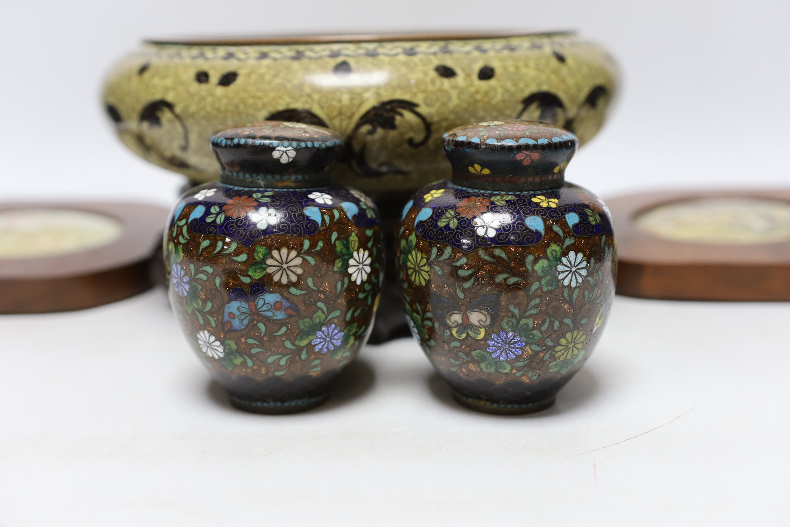 A Chinese cloisonné enamel bowl on a wooden stand, a pair of cloisonné jars with covers, and four 19th century Prattware pot lids, largest 25cm in diameter